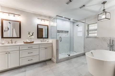 a spacious bathroom with a double vanity sink mirror and double