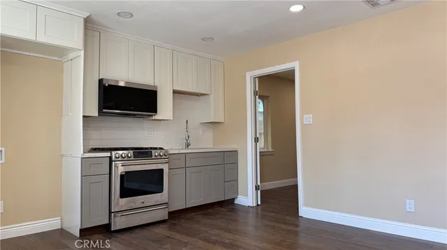 a kitchen with a stove and a microwave