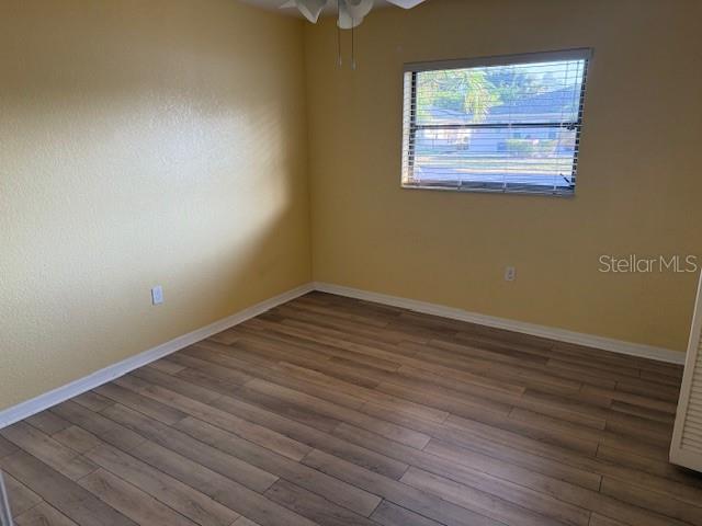 24540 Harbor View Road, Unit H2 Punta Gorda, FL 33980 - Photo 13 of 21 an empty room with wooden floor and windows