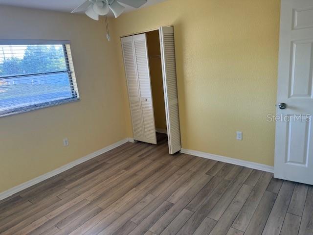 24540 Harbor View Road, Unit H2 Punta Gorda, FL 33980 - Photo 14 of 21 an empty room with wooden floor and windows