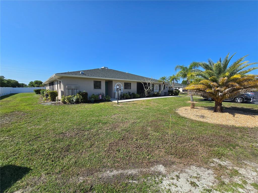 24540 Harbor View Road, Unit H2 Punta Gorda, FL 33980 - Photo 20 of 21 a view of a house with a yard
