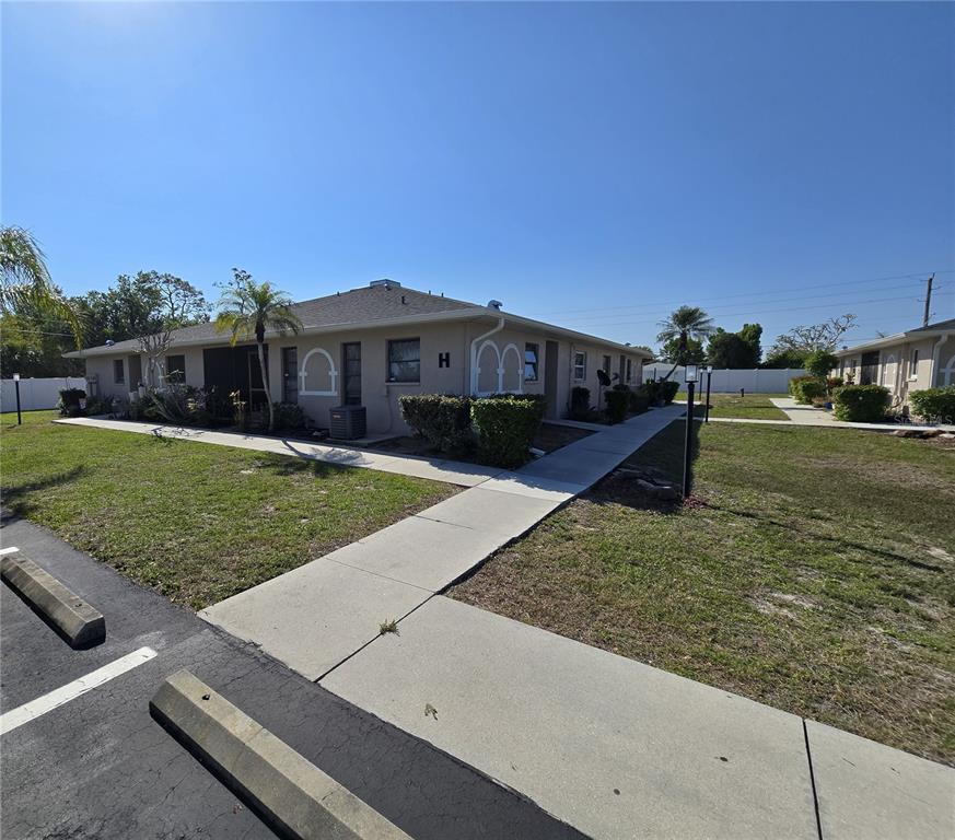 24540 Harbor View Road, Unit H2 Punta Gorda, FL 33980 - Photo 2 of 21 a view of a house with a yard