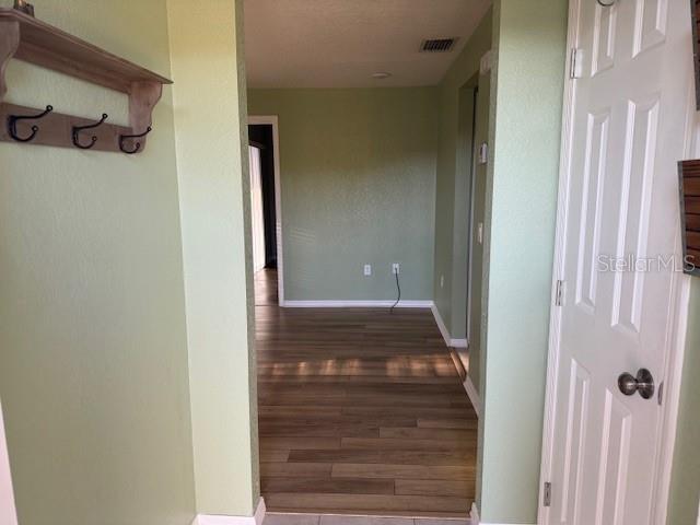 24540 Harbor View Road, Unit H2 Punta Gorda, FL 33980 - Photo 4 of 21 a view of a hallway with wooden floor and closet