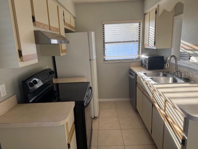 24540 Harbor View Road, Unit H2 Punta Gorda, FL 33980 - Photo 6 of 21 a kitchen with a refrigerator sink and stove