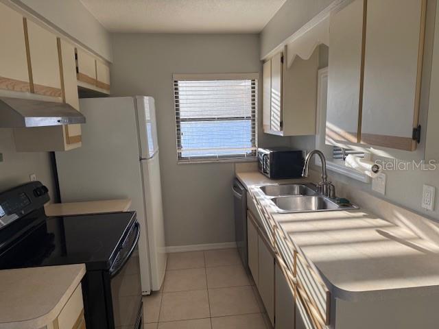 24540 Harbor View Road, Unit H2 Punta Gorda, FL 33980 - Photo 7 of 21 a kitchen with a sink stove and refrigerator