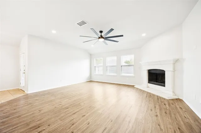 wooden floor in an empty room with a fireplace