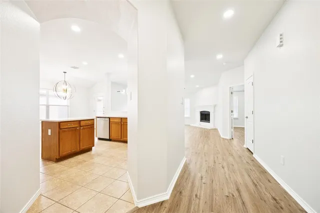 a view of a kitchen with kitchen island wooden floor center island and stainless steel appliances
