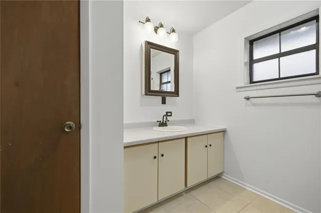 a bathroom with a toilet sink vanity and mirror
