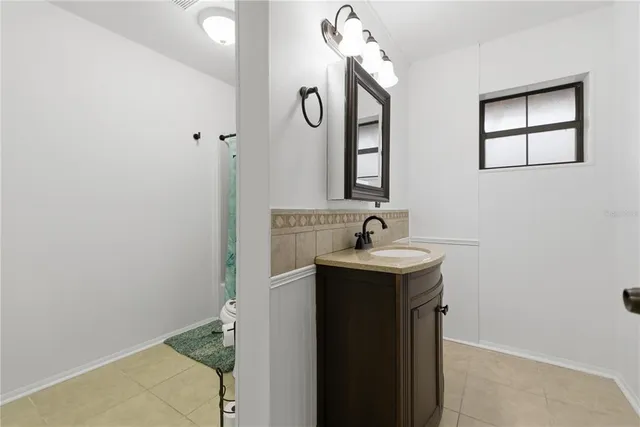 a bathroom with a sink and mirror with toilet
