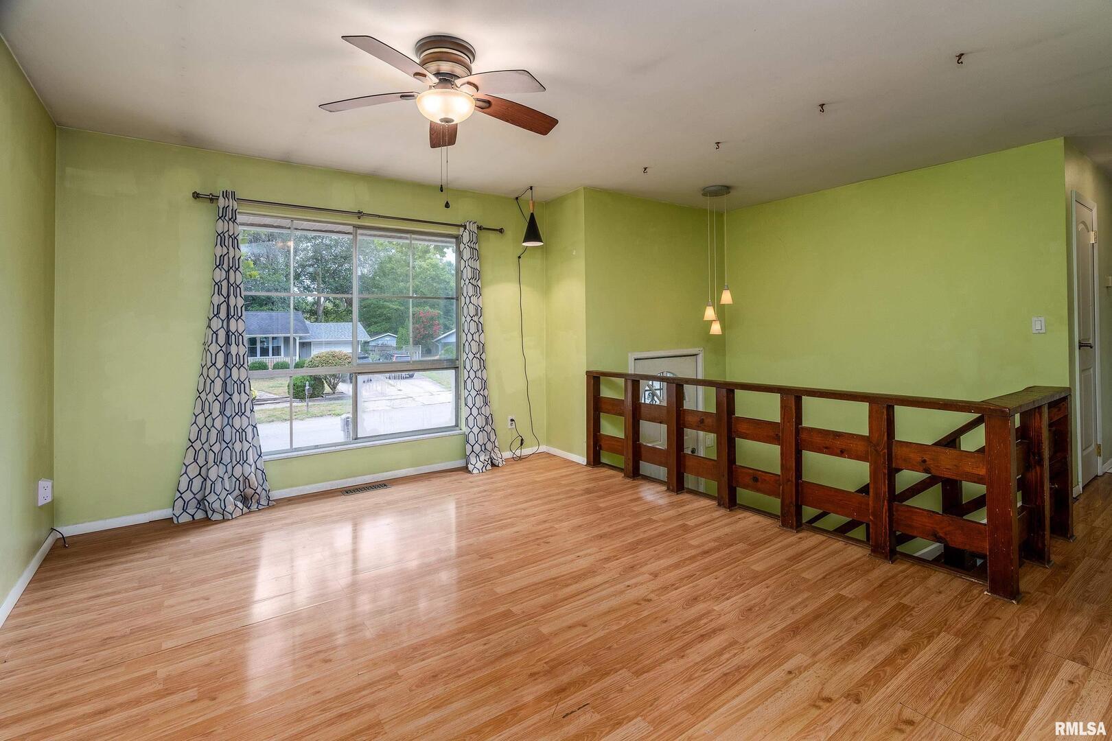 309 South Plover Drive Carbondale, IL 62901 - Photo 4 of 29 a view of an empty room with a window and wooden floor