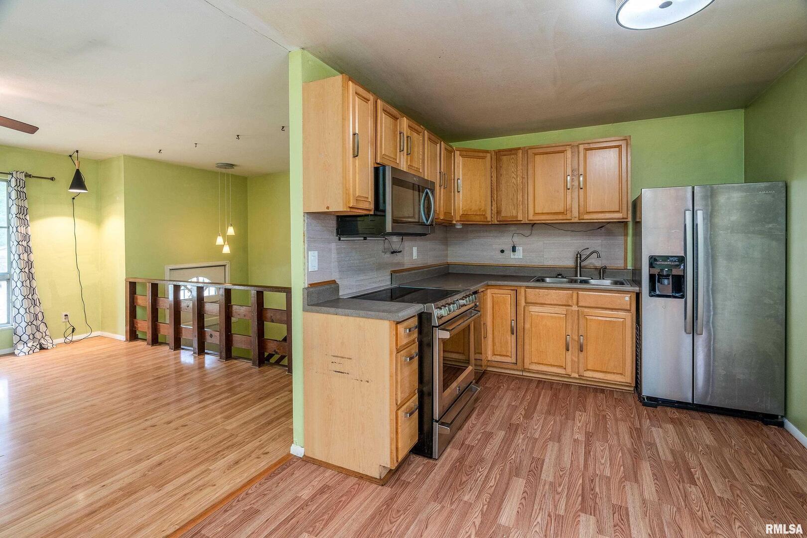 309 South Plover Drive Carbondale, IL 62901 - Photo 6 of 29 a kitchen with a sink wooden floor and stainless steel appliances