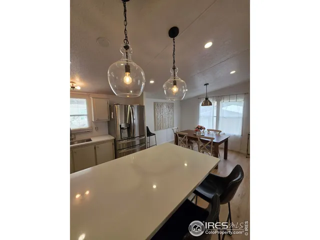 a large kitchen with a table and chairs