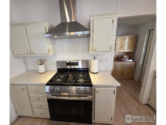 a kitchen with a stove and a refrigerator
