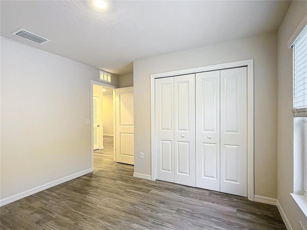 3070 East Odier Street Inverness, FL 34453 - Photo 6 of 14 an empty room with wooden floor and closet area