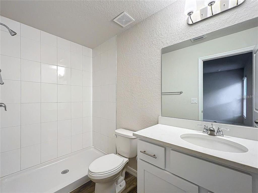 3070 East Odier Street Inverness, FL 34453 - Photo 8 of 14 a bathroom with a sink a toilet and shower