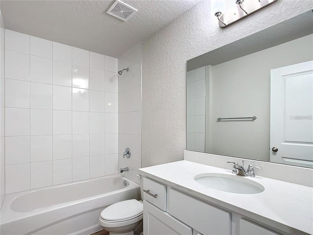 3070 East Odier Street Inverness, FL 34453 - Photo 9 of 14 a bathroom with a sink a toilet and shower