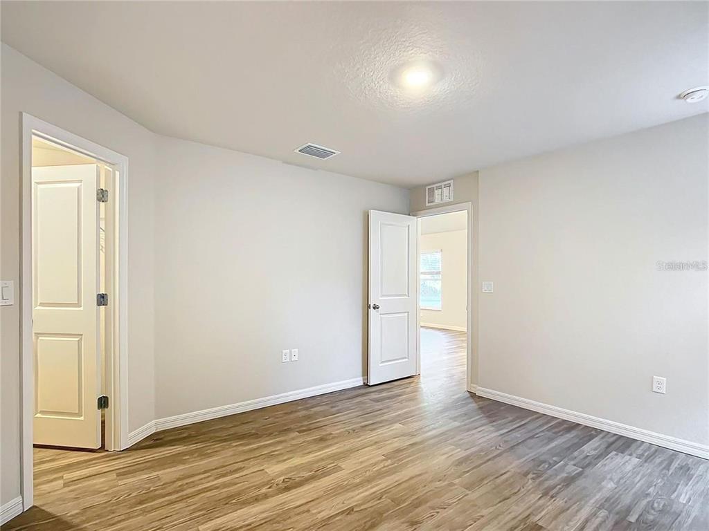 3070 East Odier Street Inverness, FL 34453 - Photo 10 of 14 a view of an empty room with wooden floor and closet