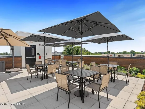 a view of a patio with a table and chairs under an umbrella