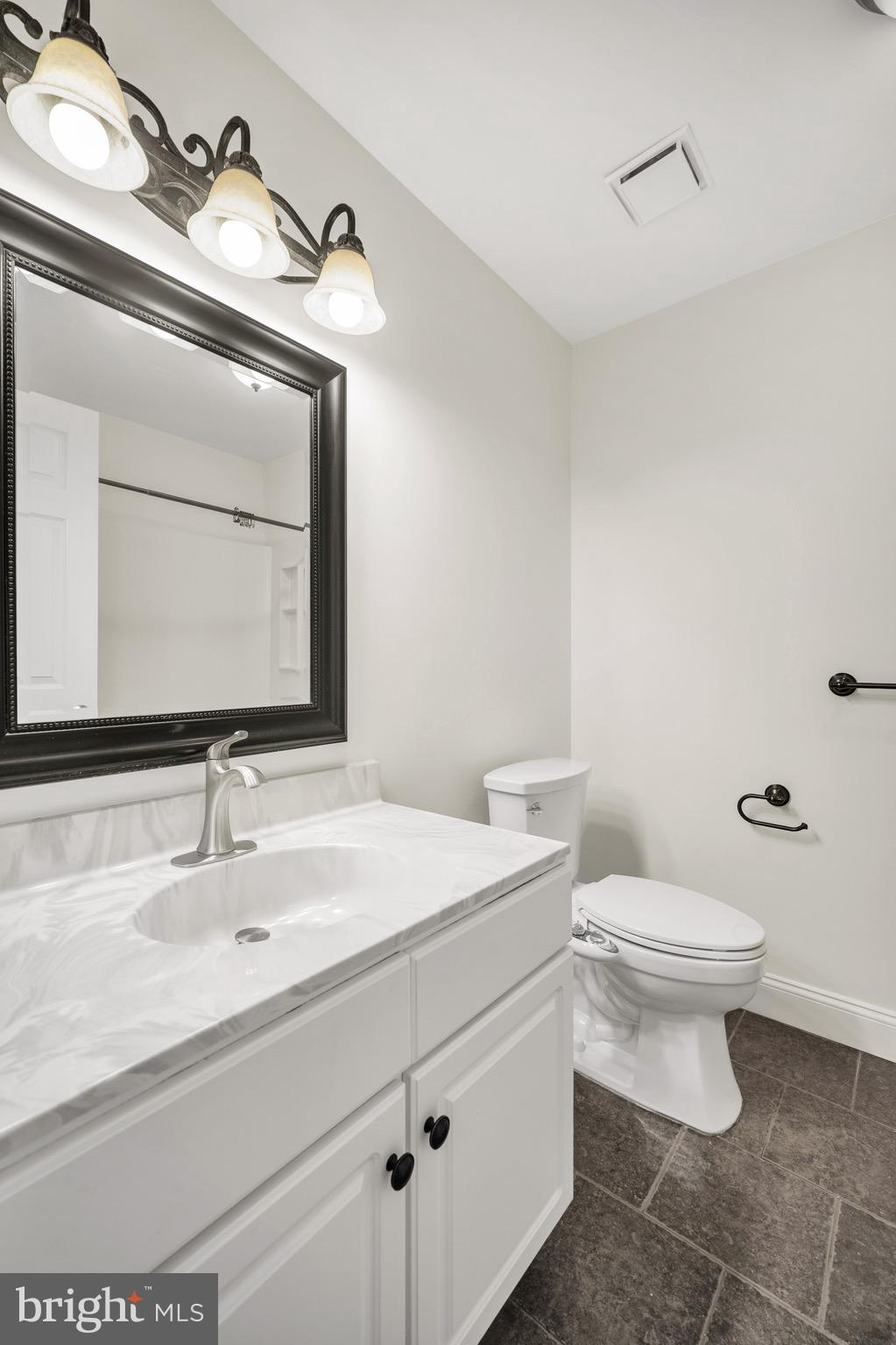 2402 Waterford Road, Unit 94 Yardley, PA 19067 - Photo 18 of 28 a bathroom with a toilet sink and mirror