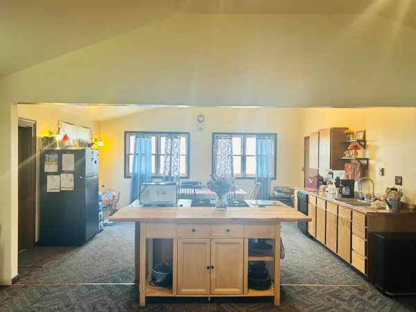a spacious bathroom with a granite countertop sink and a mirror