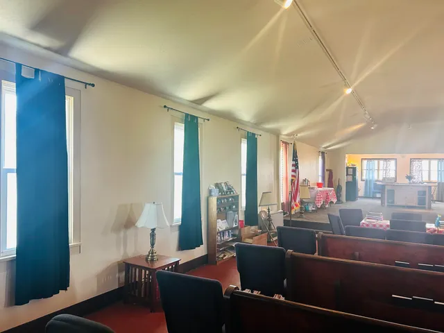 a living room with furniture and a lamp