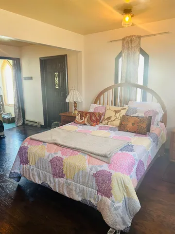 a bedroom with a bed and a mirror