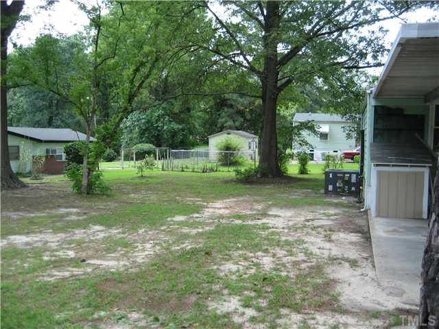 1218 Platinum Avenue Raleigh, NC 27610 - Photo 13 of 13 a view of a backyard with large trees
