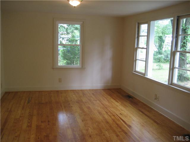 1218 Platinum Avenue Raleigh, NC 27610 - Photo 3 of 13 a view of an empty room with wooden floor and a window