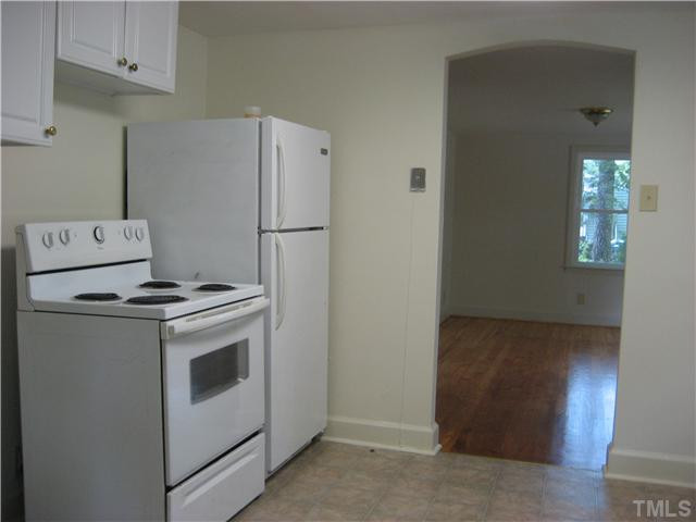 1218 Platinum Avenue Raleigh, NC 27610 - Photo 6 of 13 a kitchen with a stove and a refrigerator