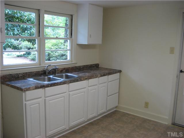 1218 Platinum Avenue Raleigh, NC 27610 - Photo 7 of 13 a kitchen with a sink and cabinets