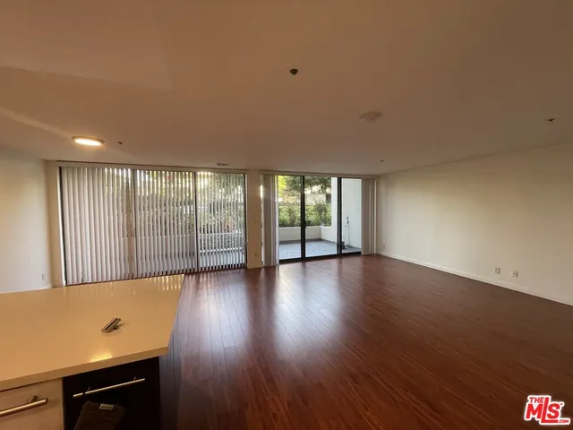 a view of a livingroom with wooden floor and a window