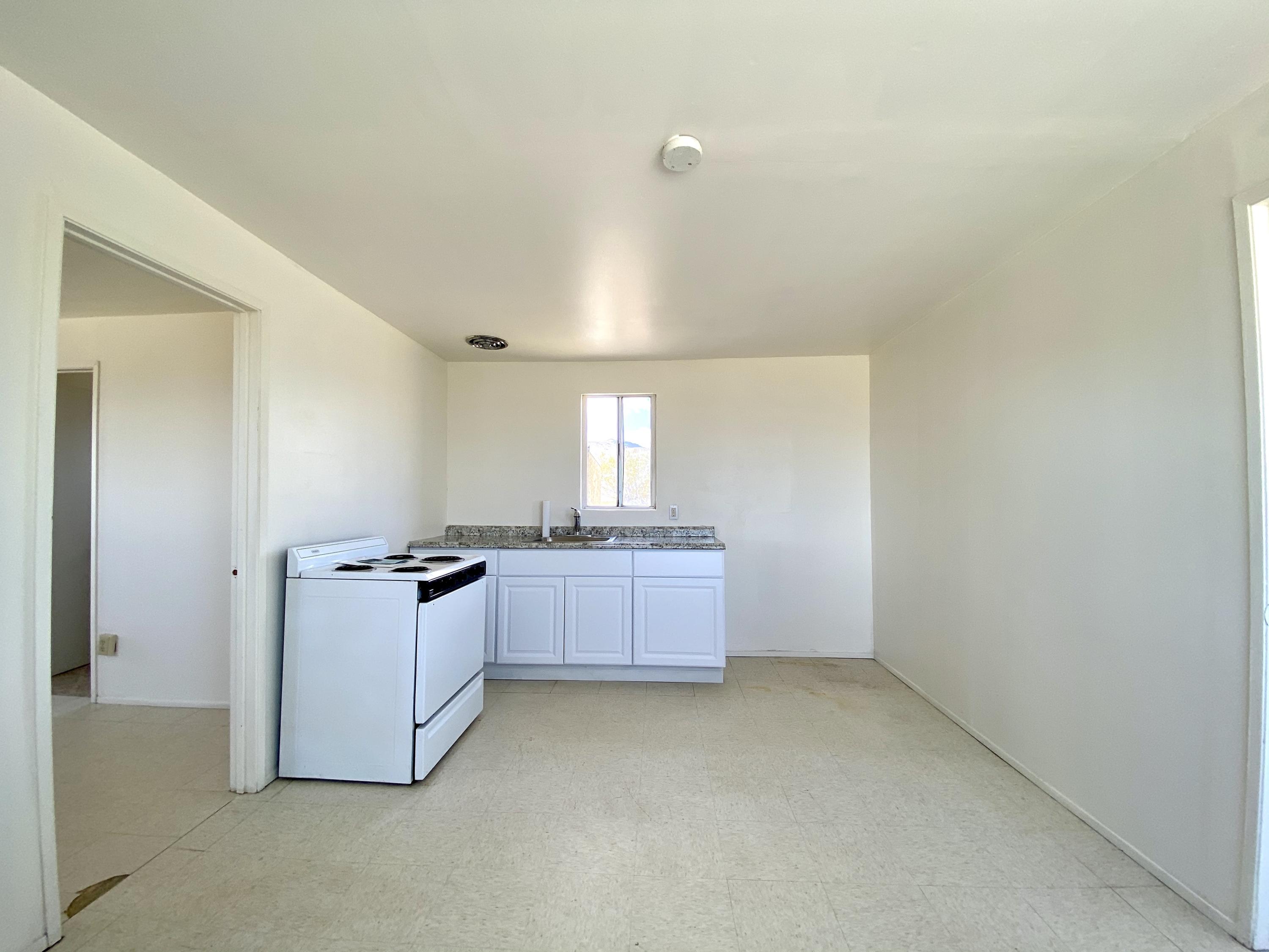 55150 Gleason Road Landers, CA 92285 - Photo 10 of 17 a room with a stove and a refrigerator