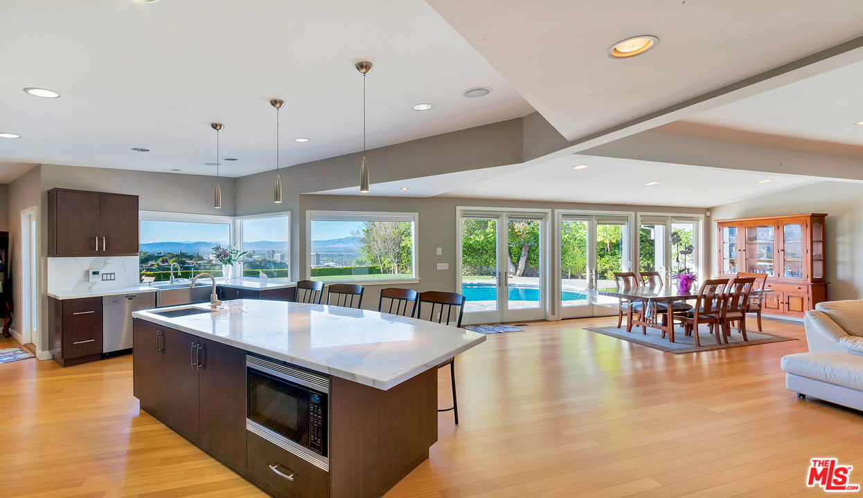 3921 Cody Road Sherman Oaks, CA 91403 - Photo 9 of 36 a kitchen with stainless steel appliances granite countertop a sink and a stove