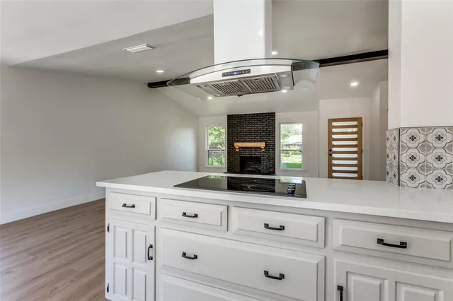 a kitchen with granite countertop white cabinets and white appliances