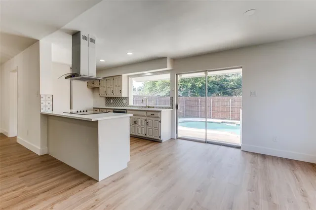 a kitchen with stainless steel appliances granite countertop a stove top oven and sink