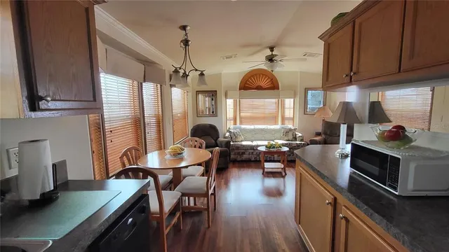 a kitchen with a sink a stove and chairs