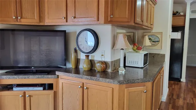 a kitchen with granite countertop a sink a stove and cabinets