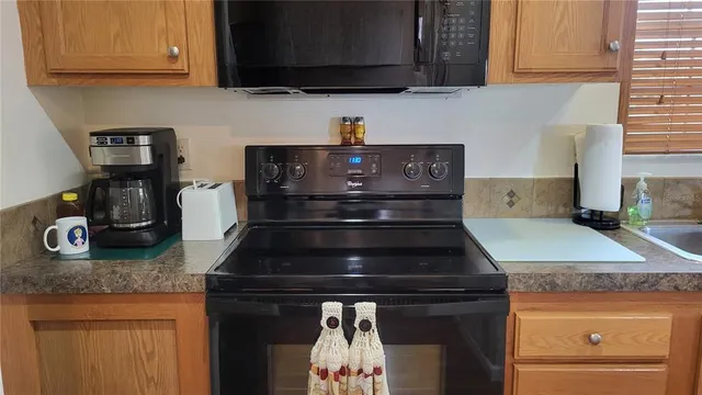 a stove top oven sitting inside of a kitchen