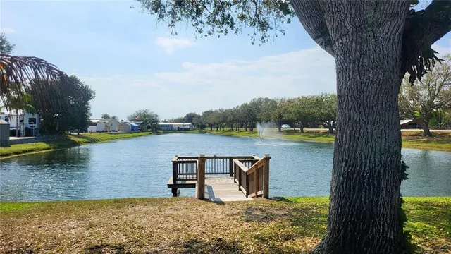 a view of a lake with a bench in the patio