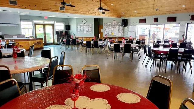 a dining hall with dining table and a large window