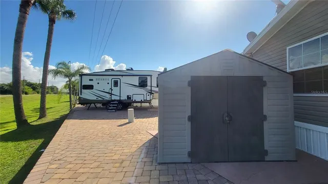 a view of a patio with table and chairs potted plants