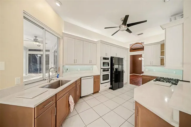 a kitchen with stainless steel appliances a sink and a refrigerator