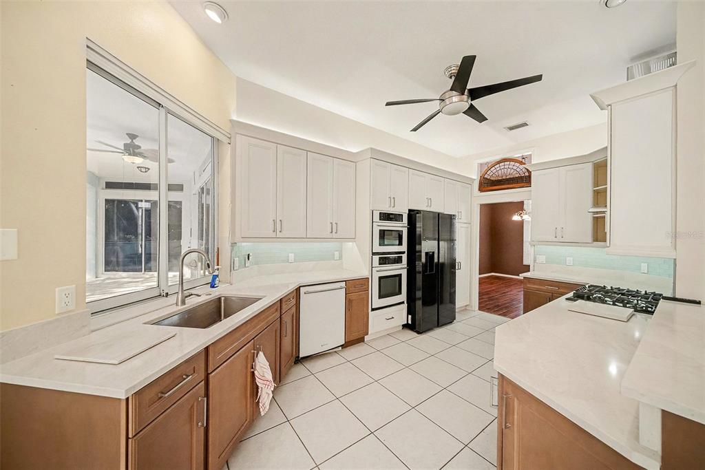 8402 Maybelle Drive Weeki Wachee, FL 34613 - Photo 15 of 41 a kitchen with stainless steel appliances a sink and a refrigerator
