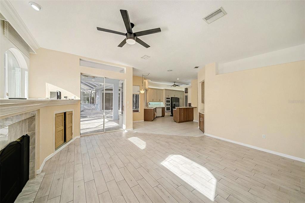 8402 Maybelle Drive Weeki Wachee, FL 34613 - Photo 18 of 41 a living room with furniture and a fireplace