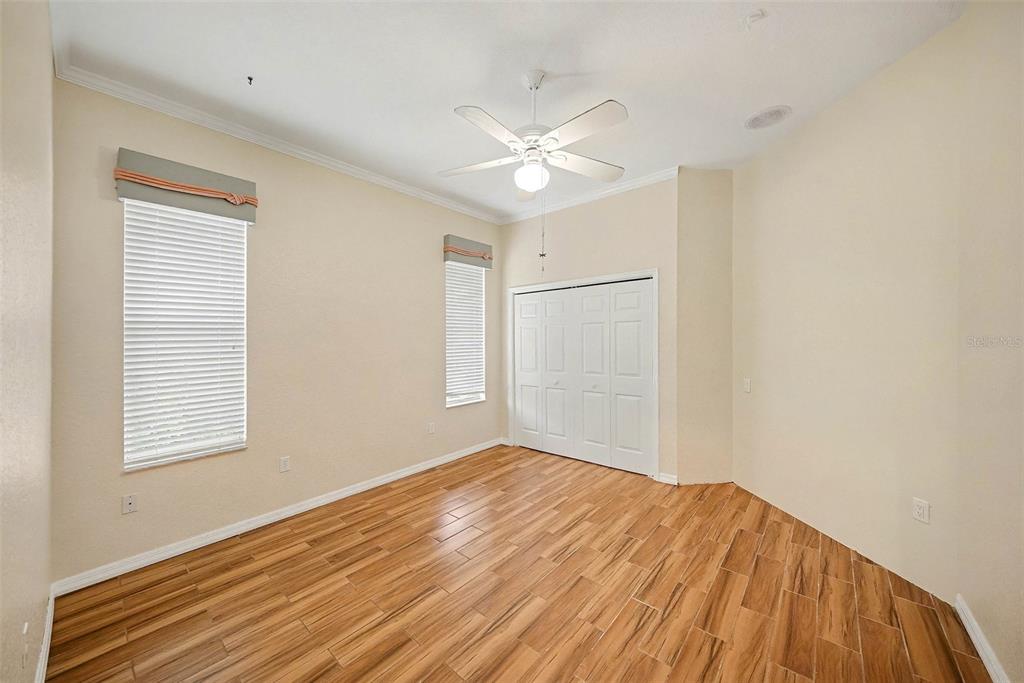 8402 Maybelle Drive Weeki Wachee, FL 34613 - Photo 19 of 41 a view of empty room with wooden floor and fan
