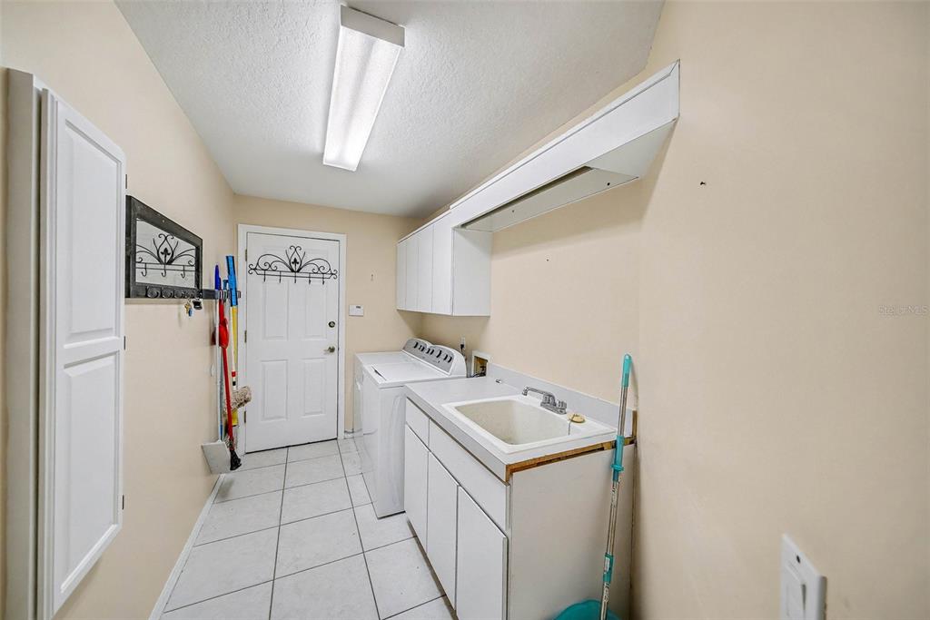 8402 Maybelle Drive Weeki Wachee, FL 34613 - Photo 23 of 41 a utility room with dryer and washer