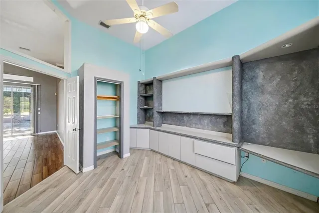 a kitchen with stainless steel appliances a sink and wooden floor