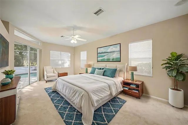 a bedroom with a large bed and windows