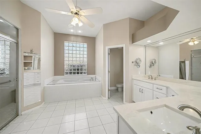 a spacious bathroom with a tub sink shower and mirror
