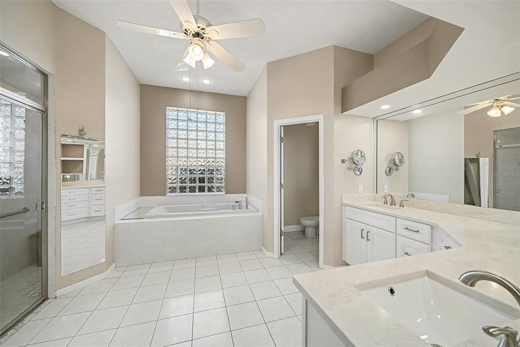 8402 Maybelle Drive Weeki Wachee, FL 34613 - Photo 28 of 41 a spacious bathroom with a tub sink shower and mirror